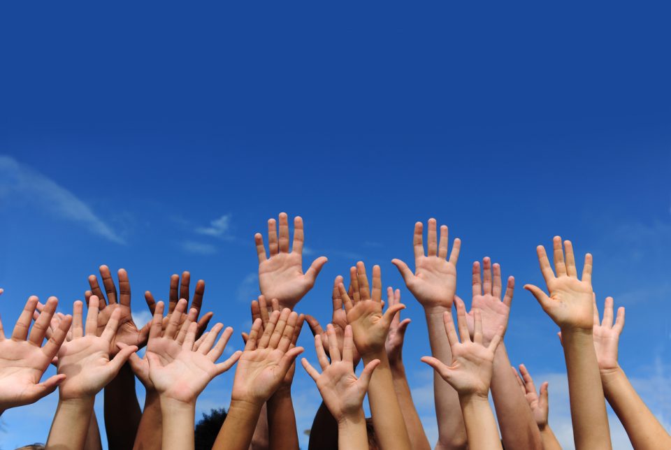 Hands against blue sky