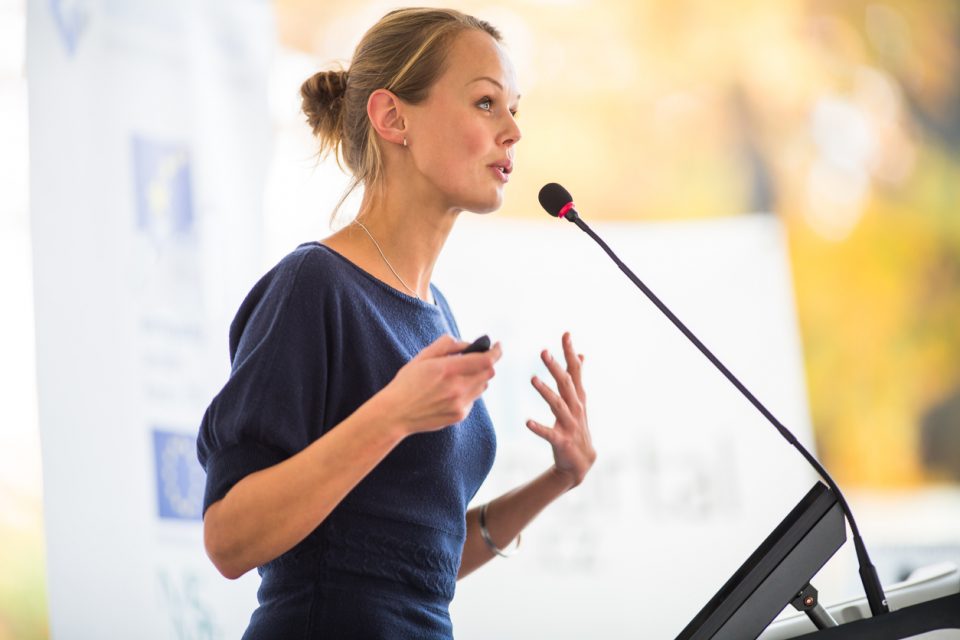 Pretty, young business woman giving a presentation