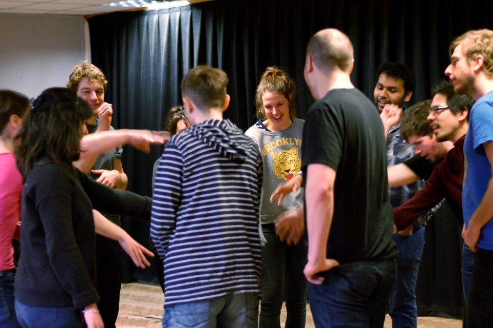 A group of people pointing and laughing